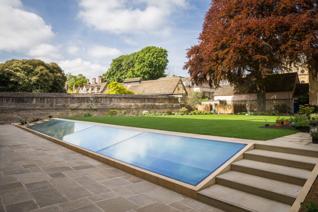 Photograph of the garden of the Provost’s lodgings at Queen’s, taken from the end nearest the Library. The photo looks out across the New Library light well, which is in the lawn of the garden, towards the old walls and Lodgings buildings.