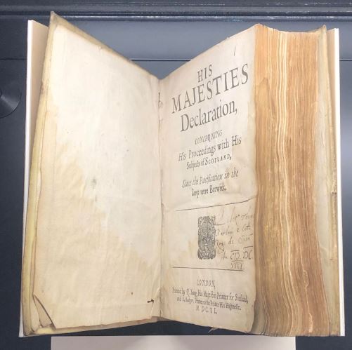 The book 'A Form of Common Prayer; to be used on the eighth of July (1640)', mounted in a cradle so the title page is visible.