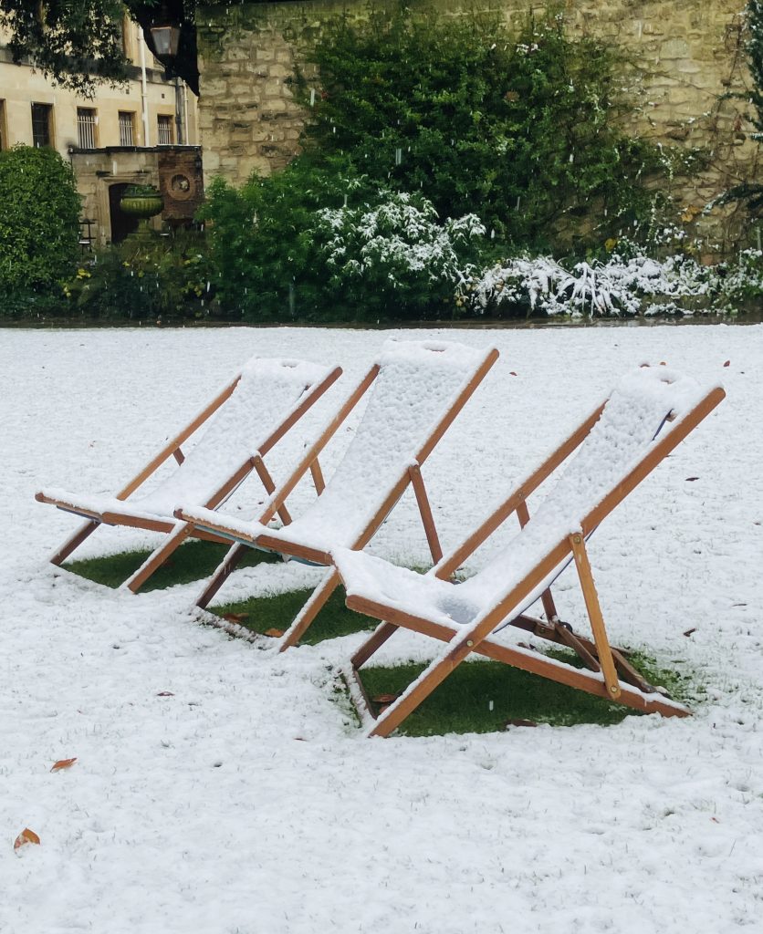 A photo of three deckchairs covered in snow in the College garden. 1st Place winner in the Perception category. Title: A Taste Of Summer Or A Taste Of Winter Yu Hang Hui