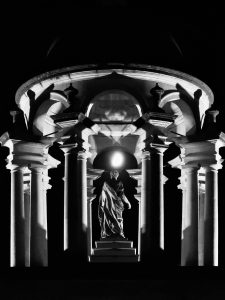 A black and white photo of the cupola at night with the moon shining through the cupola above Queen Caroline's head. 3rd Place Queen's Now category. Title: The Queen And Moon by Ziyang Qi